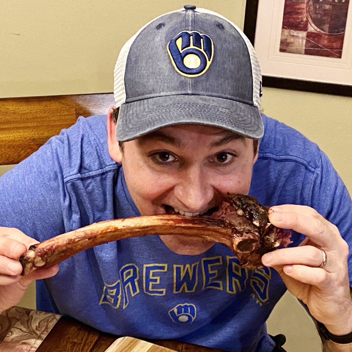 Gnawing on a tomahawk steak like a true caveman.