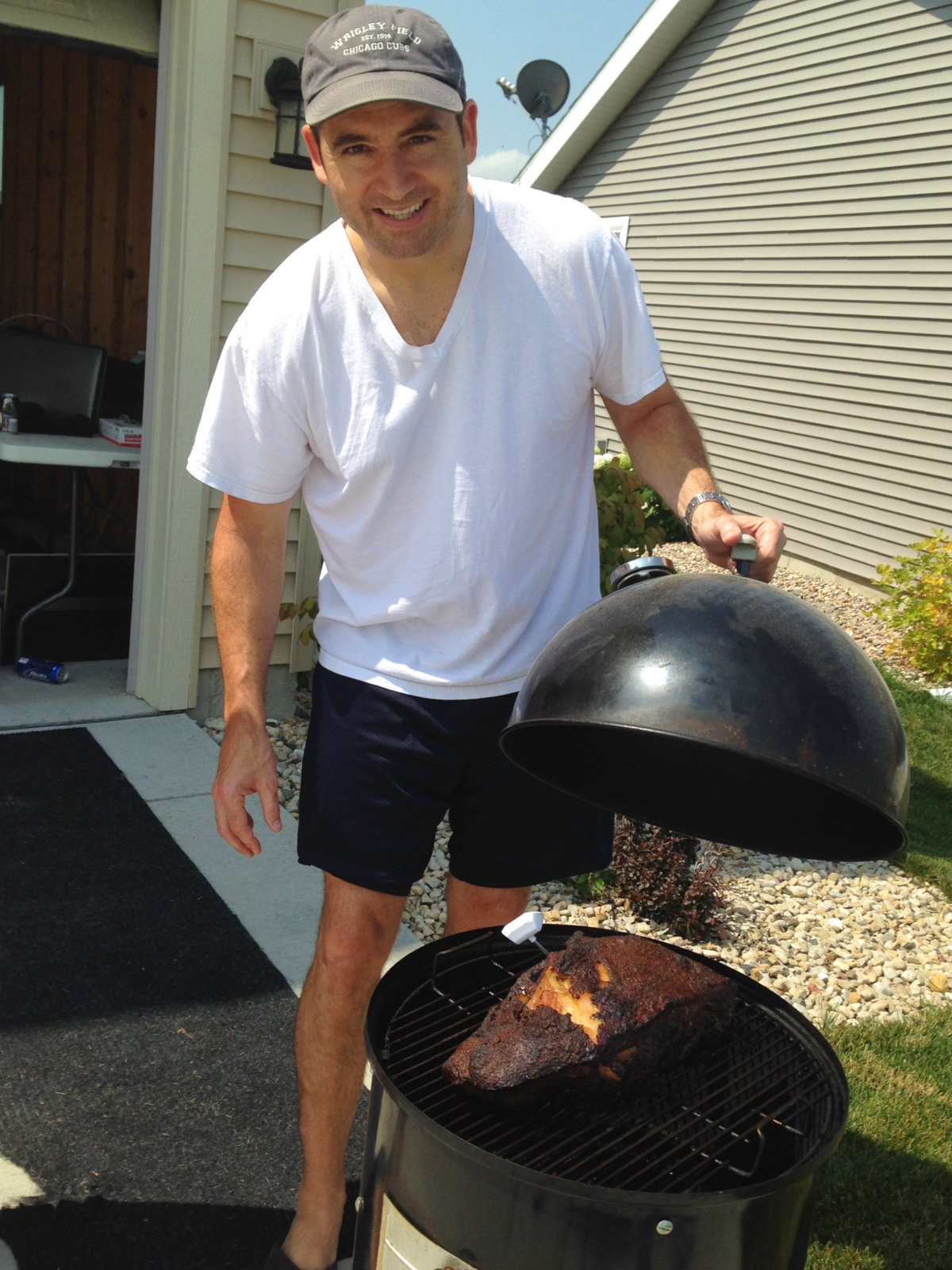 Smoking a pork butt on my old kettle smoker.